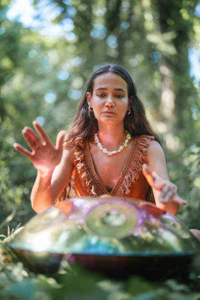 istock Environmentalist woman playing handpan in forest 2167918191