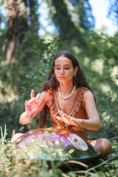 istock Environmentalist woman playing handpan in forest 2167918193