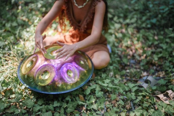 istock Environmentalist woman playing handpan in forest 2167918196