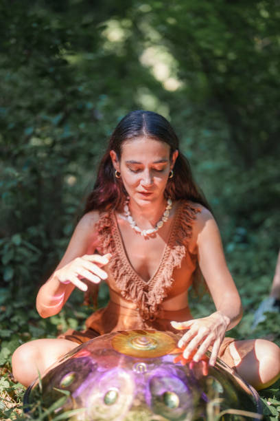 istock Environmentalist woman playing handpan in forest 2167918438