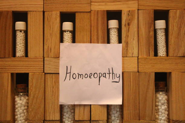Homoeopathy medicine and Healthcare. A view of wooden cabinet with glass vial and homoeopathic pills. Homoeopathy healthcare system. rajkot india stock pictures, royalty-free photos & images