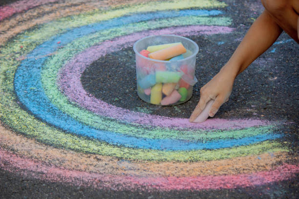 istock the boy draws with chalk on the asphalt. Selective focus 2167920046