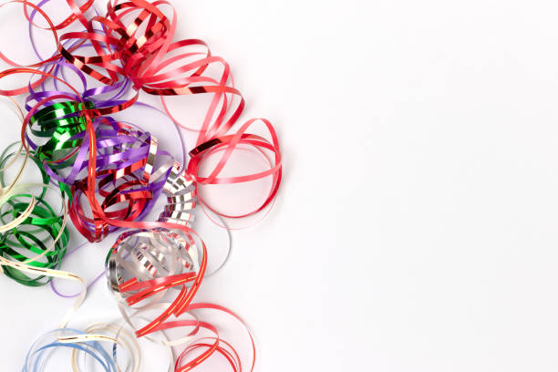 Multicolored ribbons on a blue pastel background. Festive concept with place for your design. Selective focus.