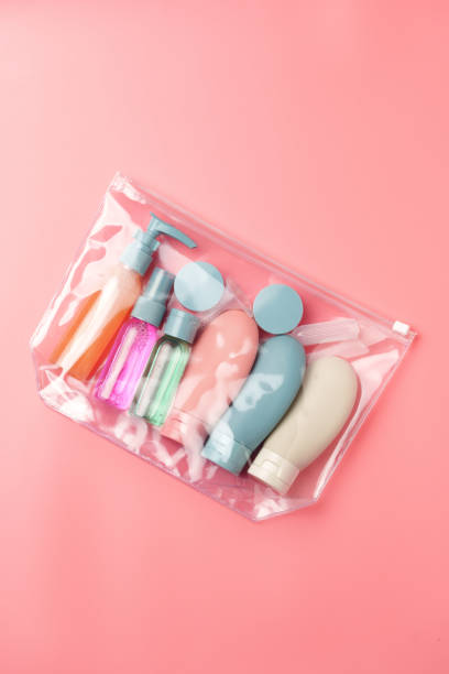 istock Clear Plastic Bag Containing Travel-Sized Toiletries on Pink Background 2167922872