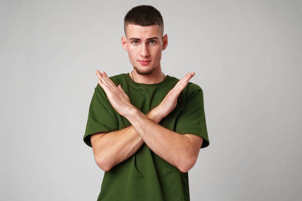 istock Young Man Making a Stop Gesture in a Green T-Shirt 2167924140