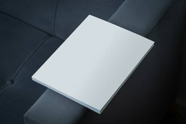 istock Stack of Magazines on a Black Leather Couch in Soft Light 2167936188