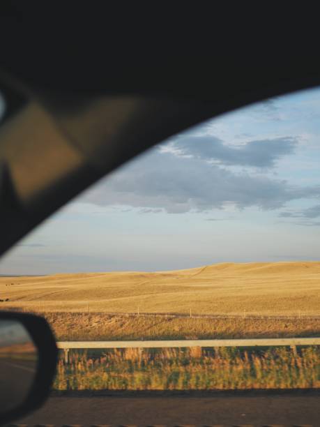 istock View out the car window at golden hour grasslands 2167937067