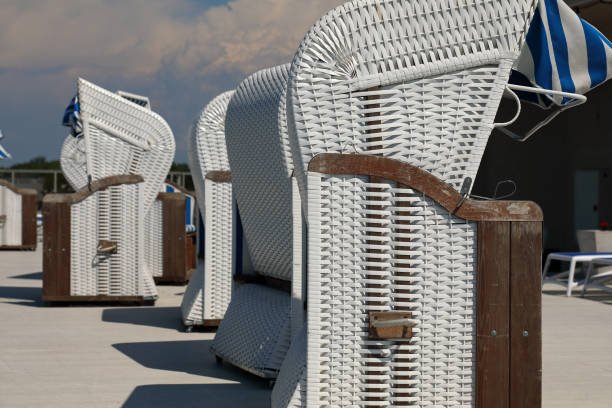 Modern wicker-style roofed beach chairs visible on a Baltic coast, Ustronie Morskie, West Pomerania, Poland