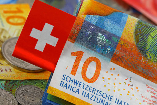 istock Swiss franc notes. A small Swiss flag is attached 2167938094