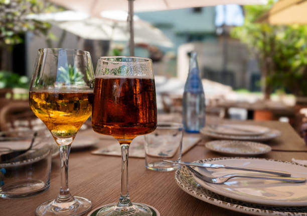 istock Two wine glasses are on a table with a blue bottle of water 2167938148