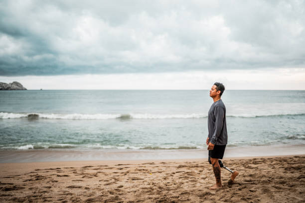 istock Mid adult man walking through the beach 2167941469