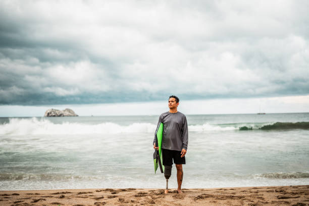 istock Mid adult surfer man contemplating while looking away on the beach 2167941780