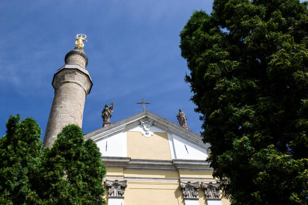 a gilded statue on a column near the cathedral