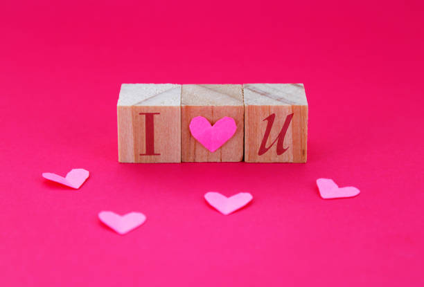 Hearts and wooden cubes with a love phrase