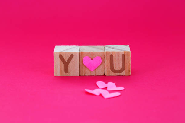Wooden cubes with a love phrase and hearts