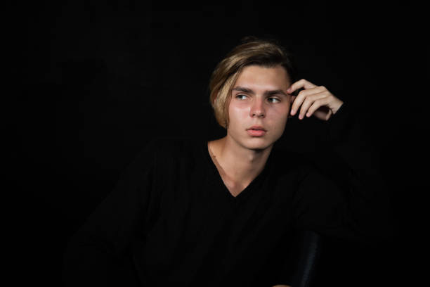 istock A young attractive guy is sad while sitting on a chair. 2167942941