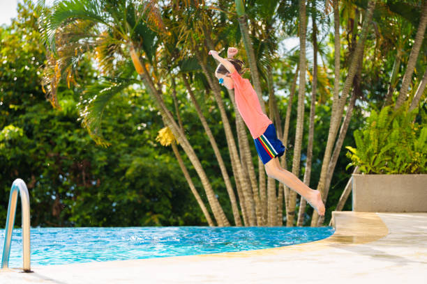 istock Kids jump into swimming pool. Summer water fun. 2167944210