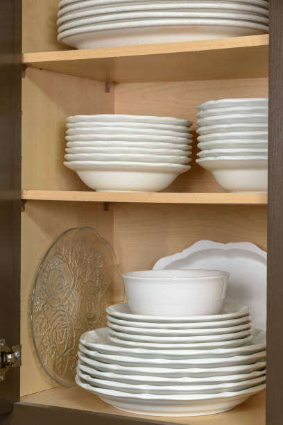 istock Clean Dishes Stacked In Cabinet Vertical 2167945365