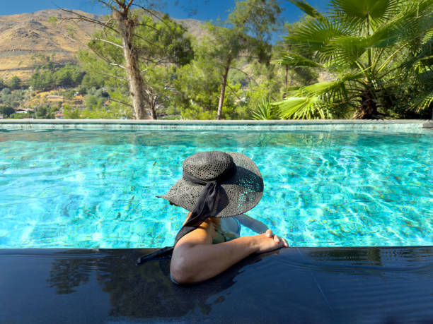 Portrait of asian woman relaxing in swimming pool with sunbathe., Summer leisure activities concept.