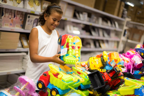 istock A cute boy choosing a toy in a toy store 2167949592