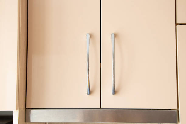 istock Beige kitchen cabinet with handles as background 2167949814