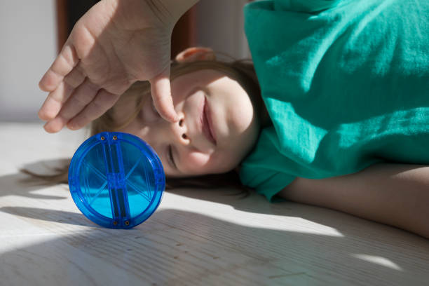 Portrait of smiling boy playing with blue transparent building block.