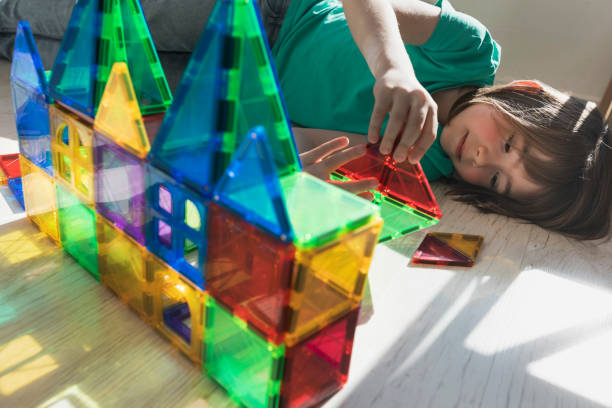 istock Happy child building a castle with transparent plastic blocks 2167951494