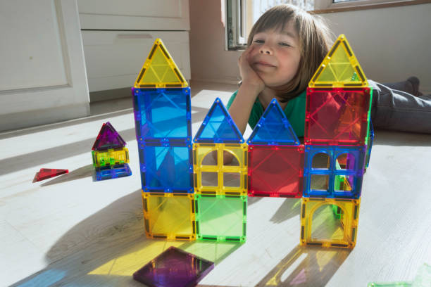 istock Happy child building a castle with transparent plastic blocks 2167951547