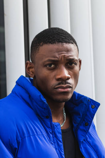 istock Black stylish man in warm jacket on street 2167951786