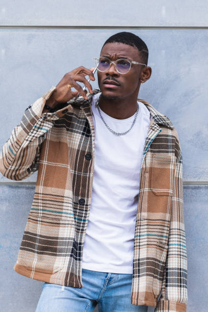 istock Stylish black male using smartphone on street 2167951979