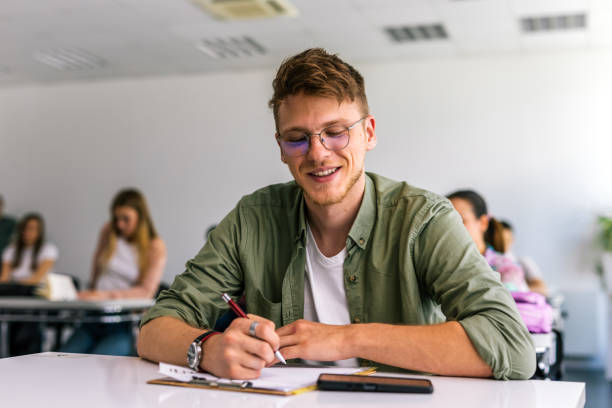 istock Portrait of male student in class writing and learning. 2167952520