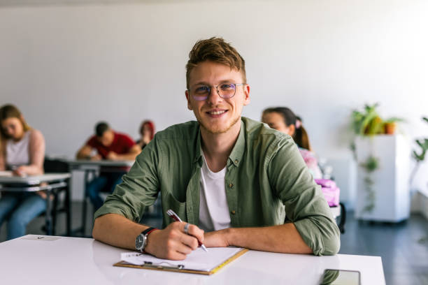 istock Portrait of male student in class writing and learning. 2167952529