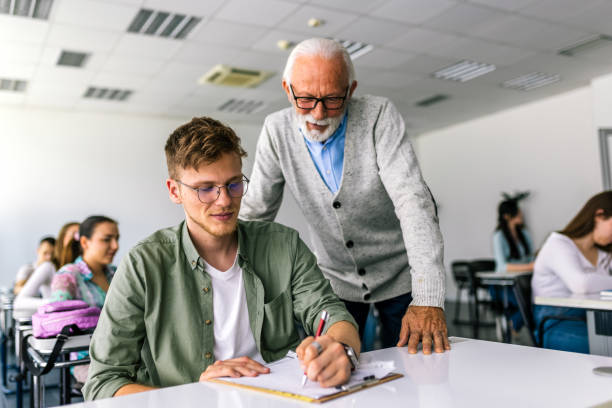 istock Senior teacher explaining a lesson to one of his students. 2167952714