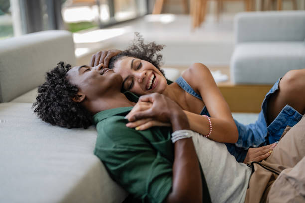 istock A young couple, relaxed and affectionate, cuddle on a cozy couch 2167955077