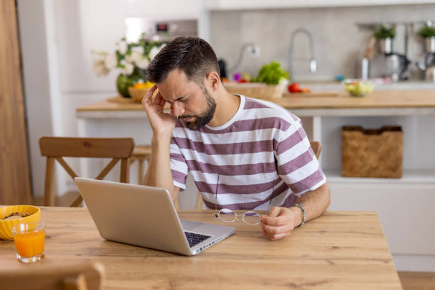 istock Man with glasses in hand working on a laptop at table 2167955153