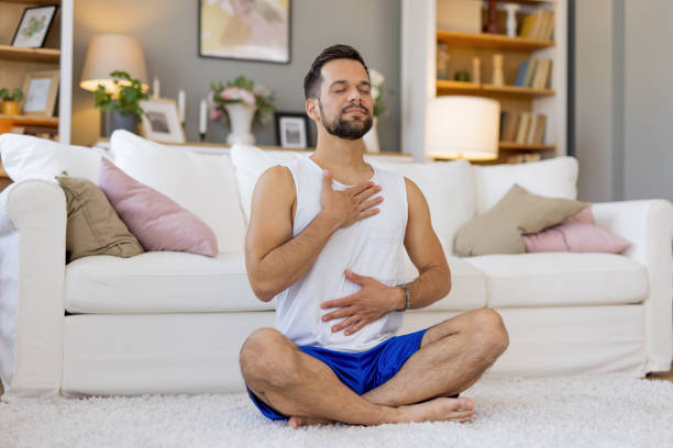 istock Person meditating with hands on chest and stomach. 2167955566