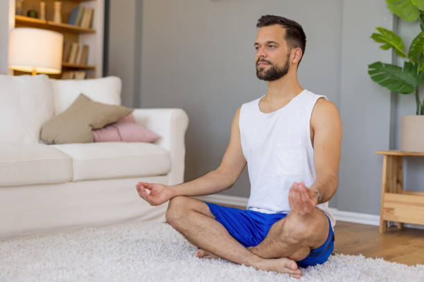 istock Person meditating cross-legged with hands on knees. 2167955578