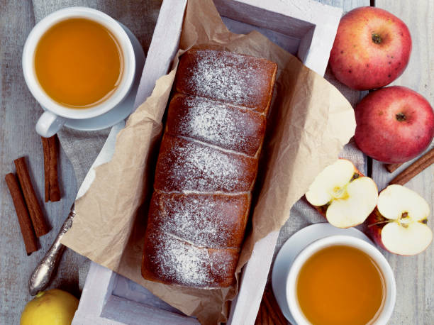 Tea Party Ready: Warm Autumn Apple Pie with Sweet Pastries, Evoking a Delightful Autumn Mood. Flat lay.
