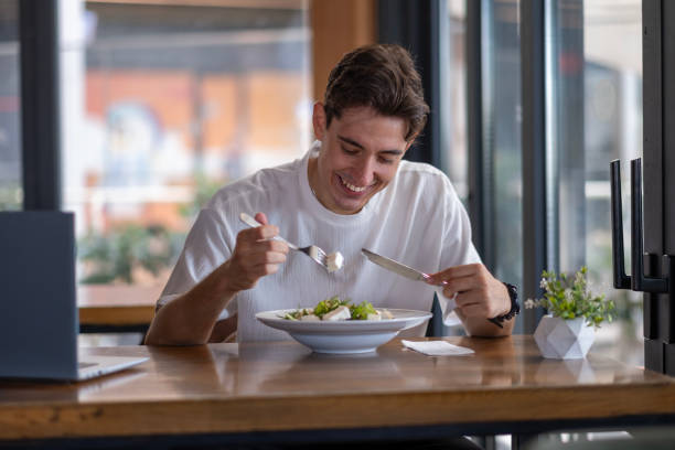 istock Man working with laptop in restaurant, taking lunch break 2167957305