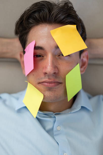 istock Portrait of young man with sticky note on his face 2167957410