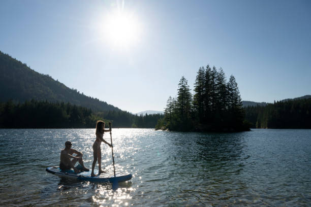 istock Father and young daughter SUP on lake 2167957881
