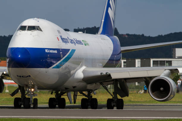 Cargo plane Boeing 747 of Nippon Cargo Airlines lining up the runway in Graz, Austria Graz, Austria - May 17, 2016: Huge cargo plane Boeing 747 of Nippon Cargo Airlines lining up the runway in Graz, Austria nippon cargo airlines photos stock pictures, royalty-free photos & images