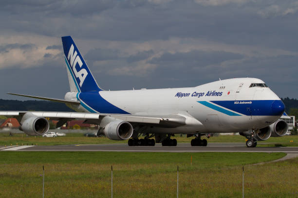 Cargo plane Boeing 747 of Nippon Cargo Airlines lining up the runway in Graz, Austria Graz, Austria - May 17, 2016: Huge cargo plane Boeing 747 of Nippon Cargo Airlines lining up the runway in Graz, Austria nippon cargo airlines photos stock pictures, royalty-free photos & images