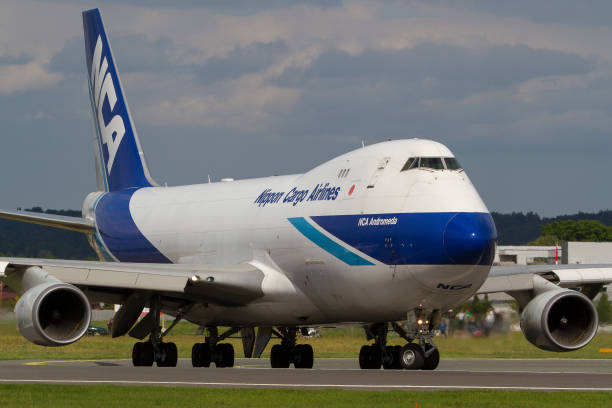 Cargo plane Boeing 747 of Nippon Cargo Airlines lining up the runway in Graz, Austria Graz, Austria - May 17, 2016: Huge cargo plane Boeing 747 of Nippon Cargo Airlines lining up the runway in Graz, Austria nippon cargo airlines photos stock pictures, royalty-free photos & images