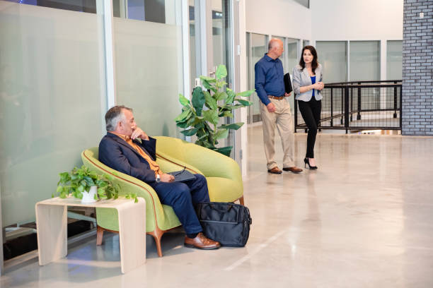 istock Active senior men coming for a job interview in an open work space. 2167959658