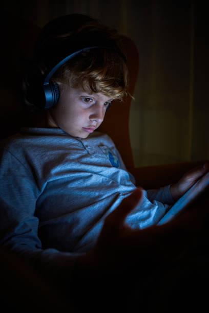 istock Boy playing videogame in darkness 2167959723