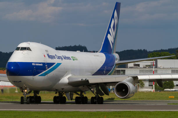 Cargo plane Boeing 747 of Nippon Cargo Airlines lining up the runway in Graz, Austria Huge cargo plane Boeing 747 of Nippon Cargo Airlines lining up the runway in Graz, Austria nippon cargo airlines photos stock pictures, royalty-free photos & images
