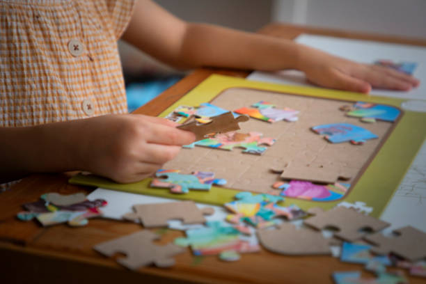 istock A little boy playing Puzzle on her desktop - 2 2167961155