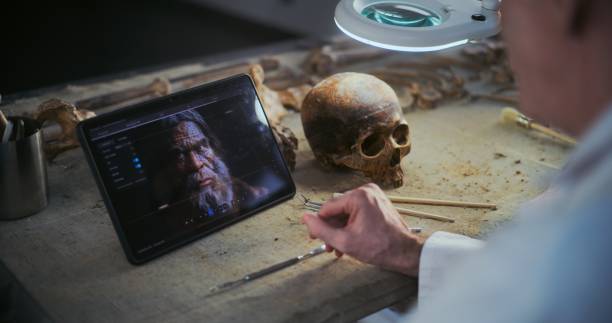 istock Two scientists examine fossil skull, discuss 3D model displayed on tablet screen 2167963261