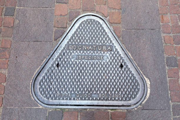 Riva Del Garda, Italy - August 14, 2024: A manhole cover on a cobblestone street